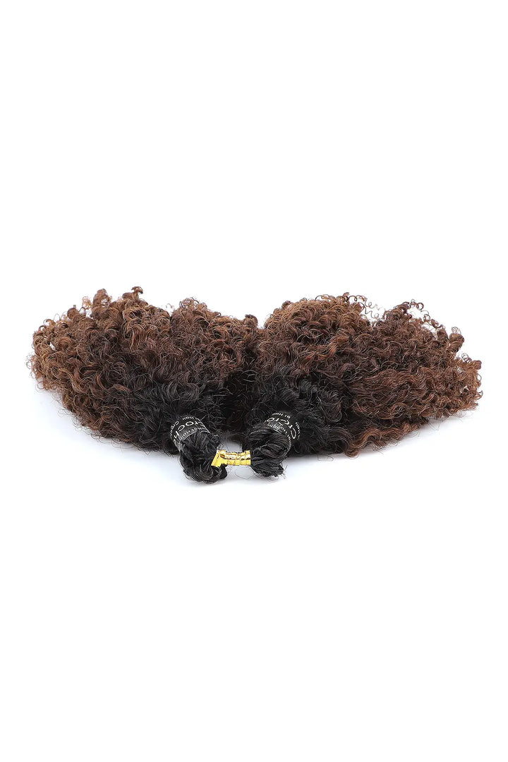 Detail of the ends of  1b/4 two tone color tight curly feather crochet human hair