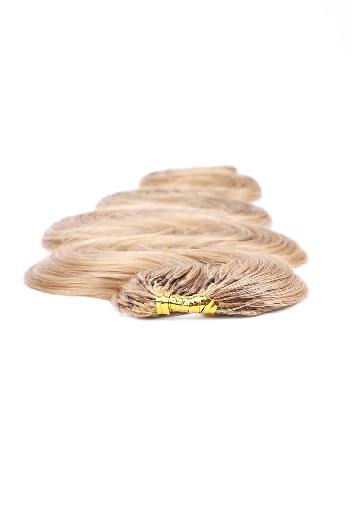 Detail of the ends of strawberry blonde  27 body wave feather crochet human hair 60g