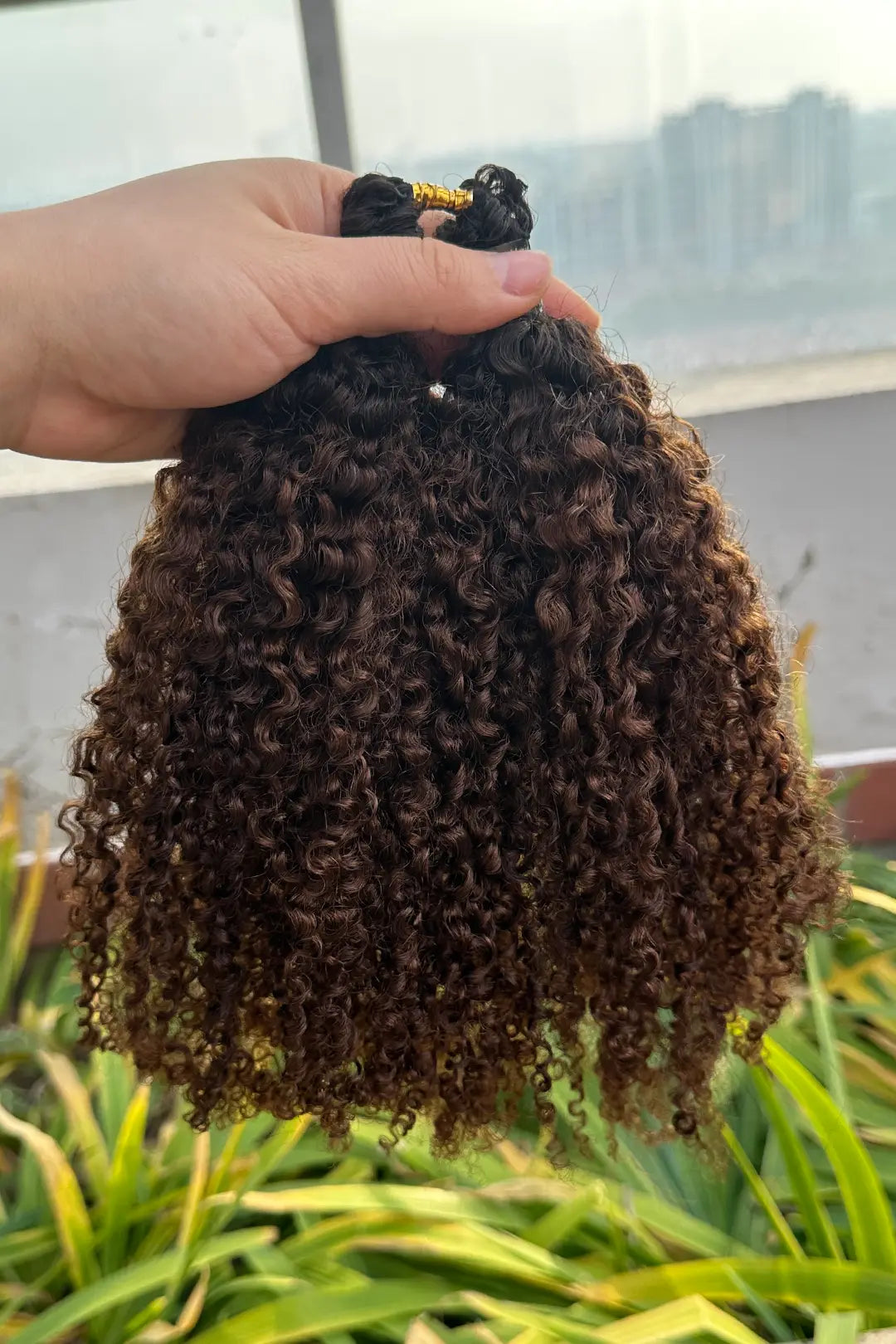 Outdoor picture of 1b/4 two tone color tight curly feather crochet human hair