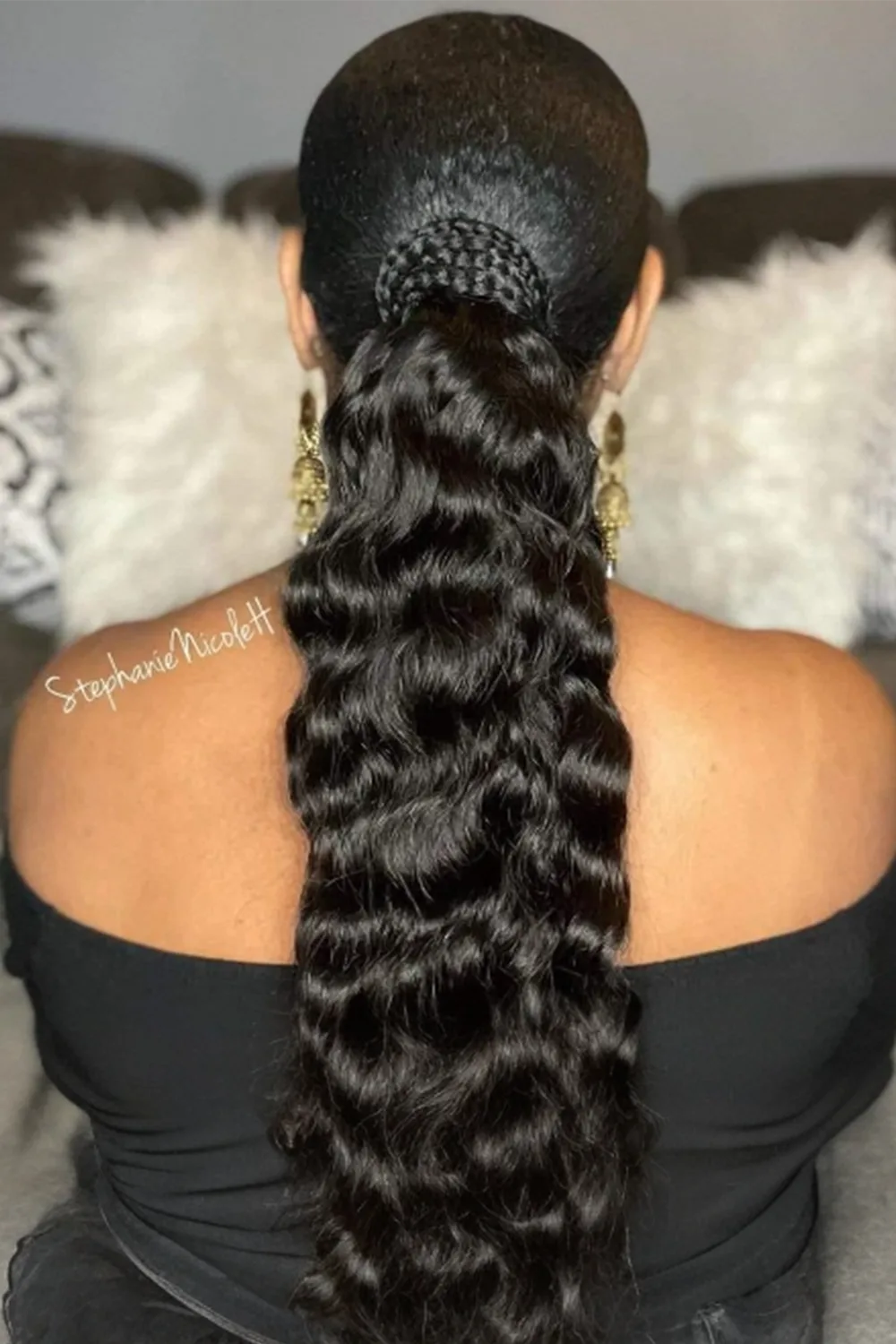 A model wears a long water wave drawstring ponytail