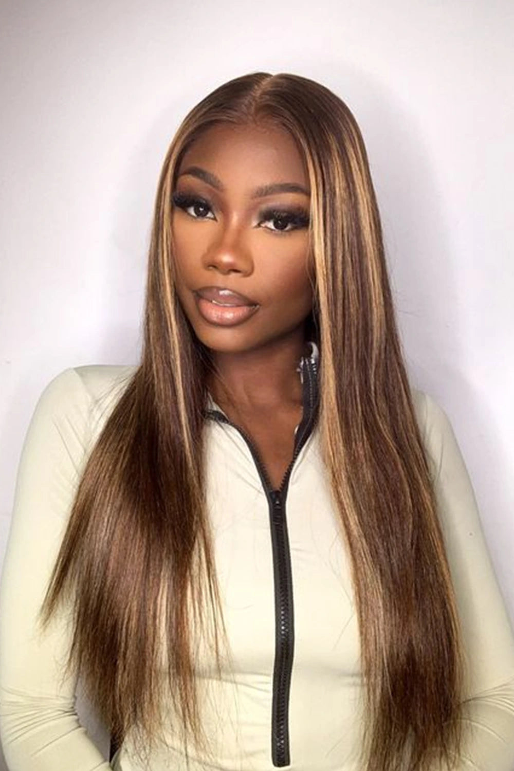 A model is showing off ygwigs' 13x6 glueless hd lace brown wig with blonde highlights bone straight 2