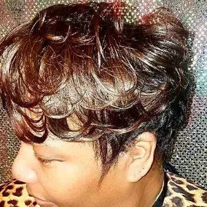 Close-up of a person with styled hair on a glittery background