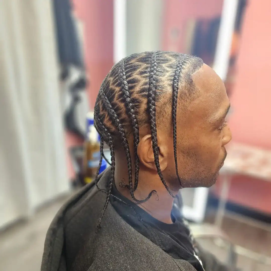 Person with styled braided hair in a salon setting