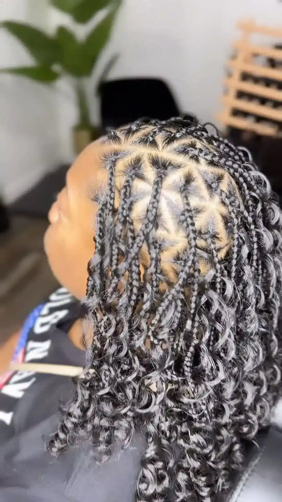 Person with braided hair in a salon setting