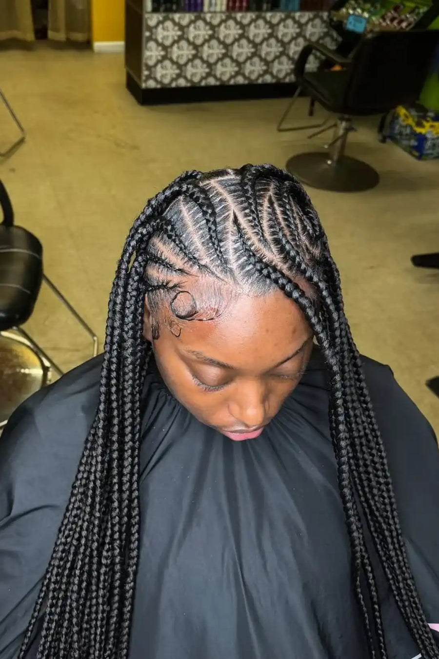 Person with braided hair in a salon setting