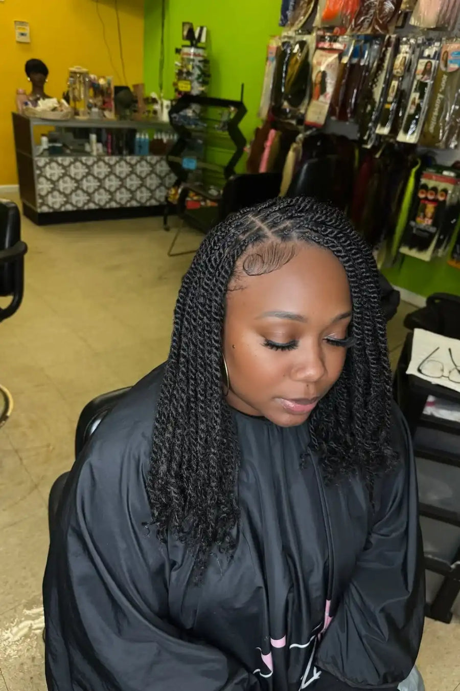 Woman with braided hair in a salon setting