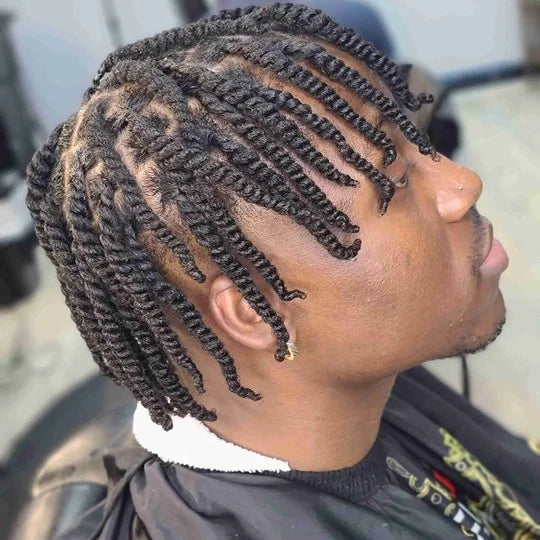 Person with styled braided hair in a salon setting
