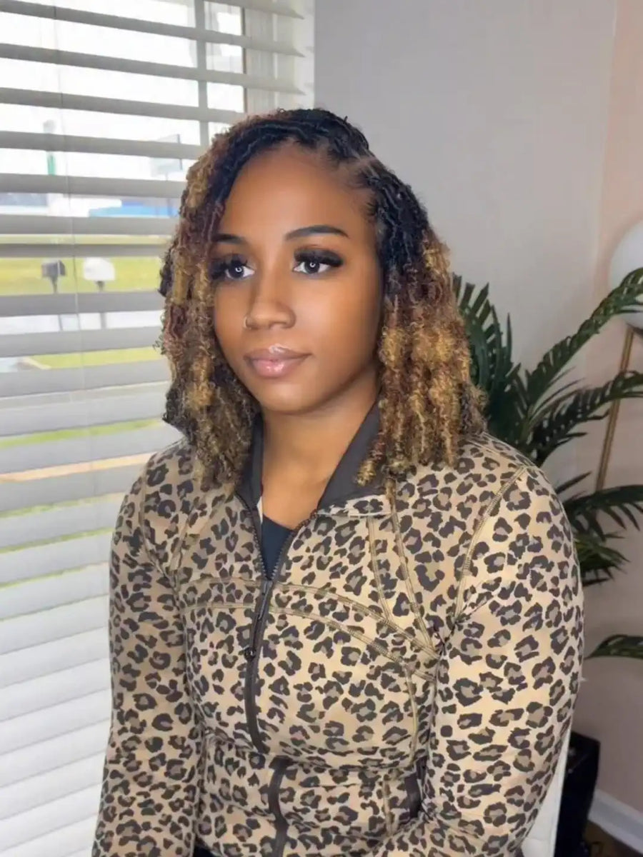 Woman wearing a leopard print jacket indoors with blinds and a plant in the background