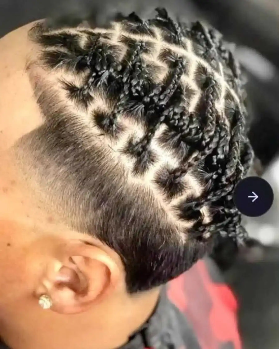 Close-up of a person with braided hair, focusing on the intricate patterns.
