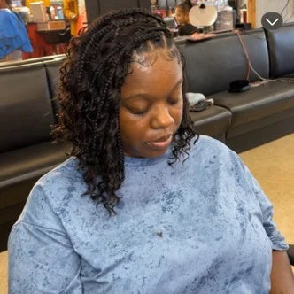 Person sitting in a waiting area wearing a blue shirt.
