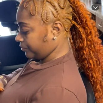 Woman with braided hair sitting inside a vehicle