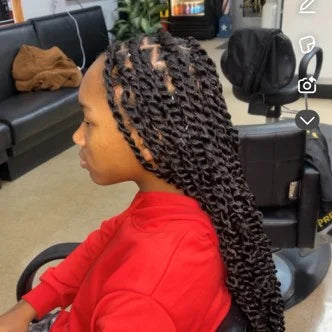 Person with braided hair in a salon setting