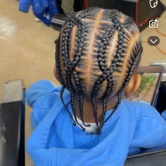 Person with braided hair wearing a blue protective gown and gloves, possibly in a salon setting.