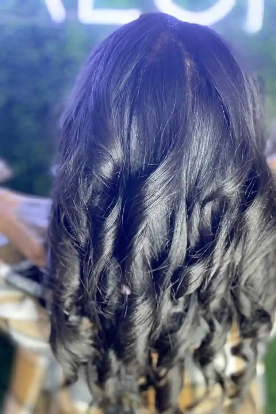 Close-up of a person with wet, dark hair outdoors