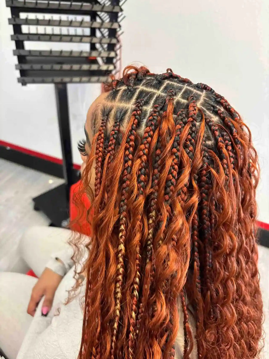 Person with long, braided hair in a salon setting