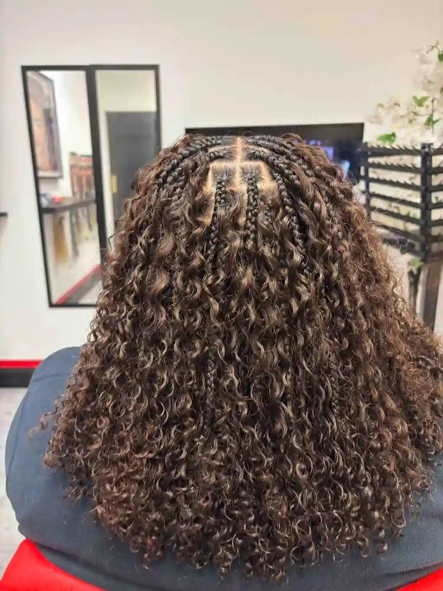 Curly hair styled in a salon setting with mirrors and decor.