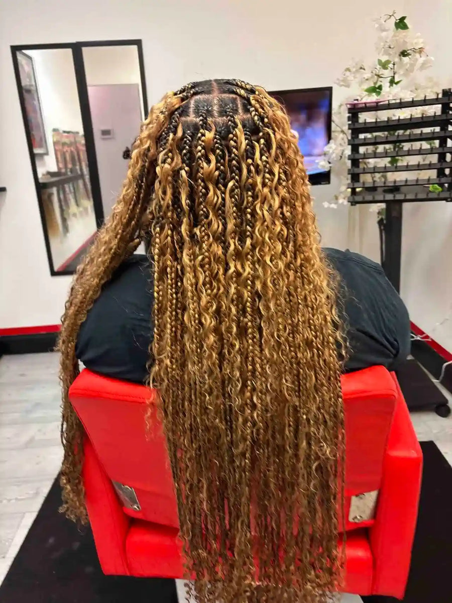 Person with long, braided hair in a salon setting