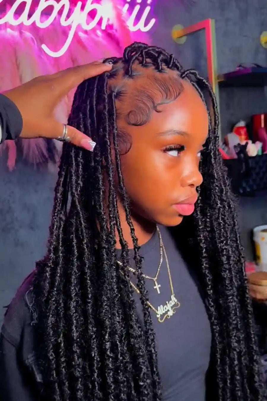 Person with styled braids in a salon setting