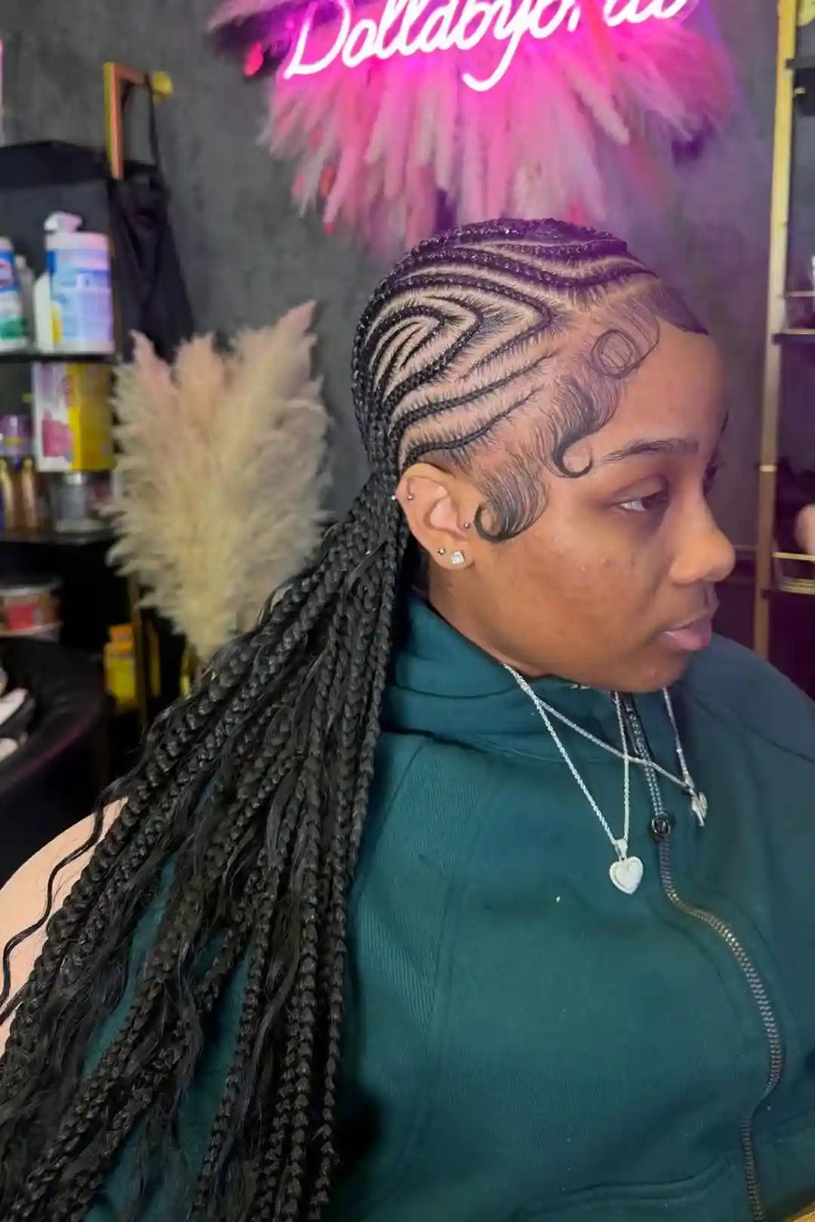 Person with styled hair in a salon setting with decorative elements.