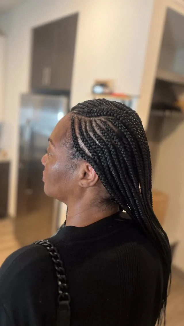 Person with braided hair in a kitchen setting