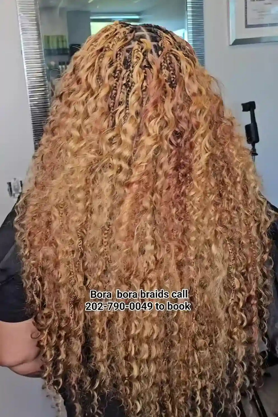 Person with long, styled hair in a salon setting