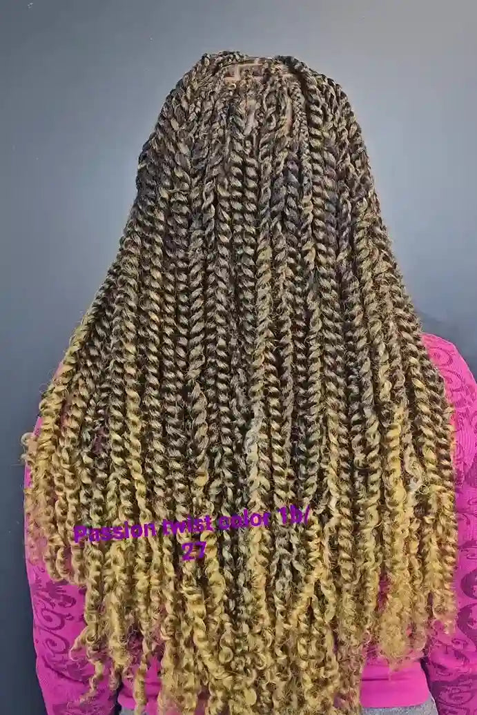 Long braided hair with color gradient from black to blonde on a plain background