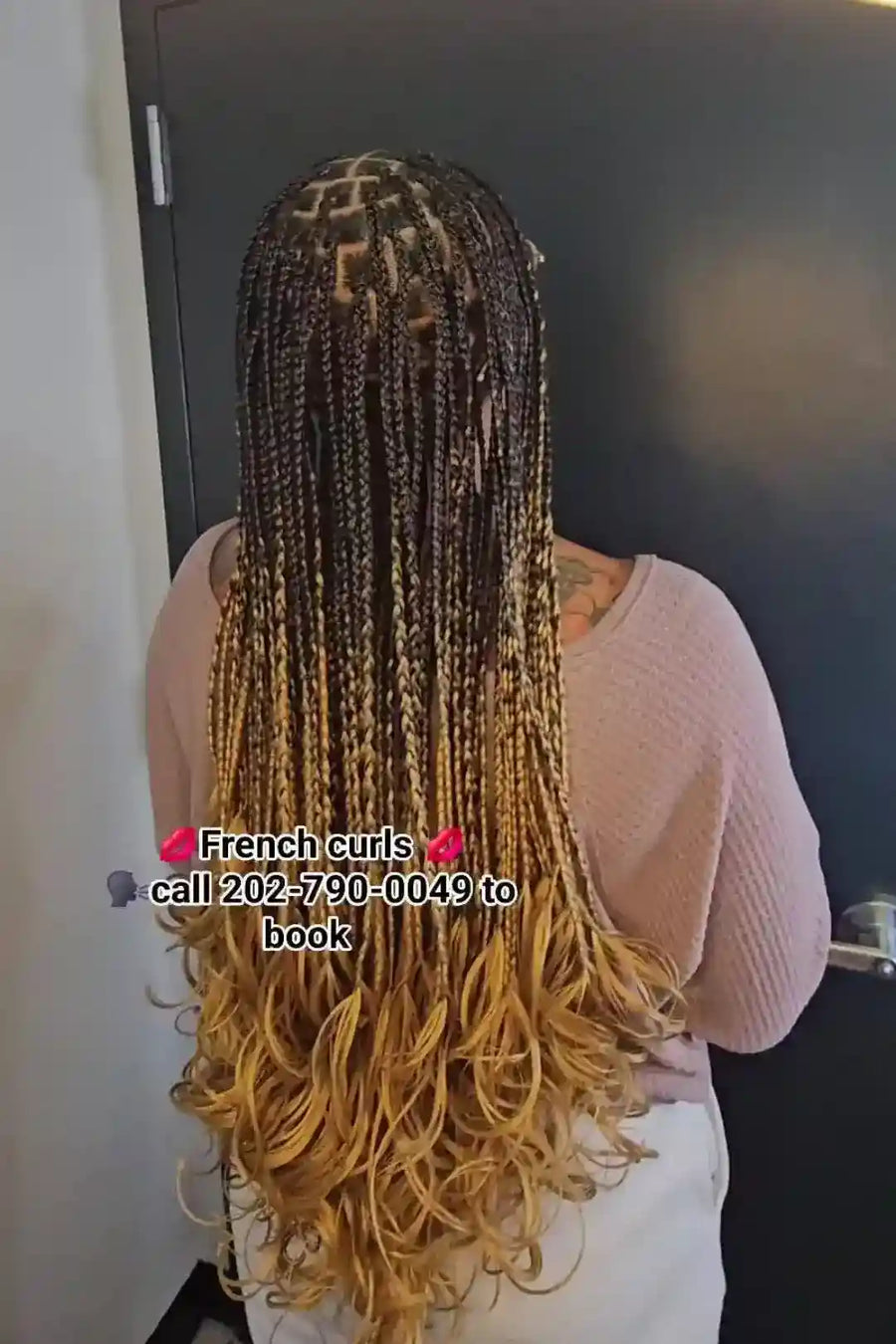 Person with long, styled hair in a room.