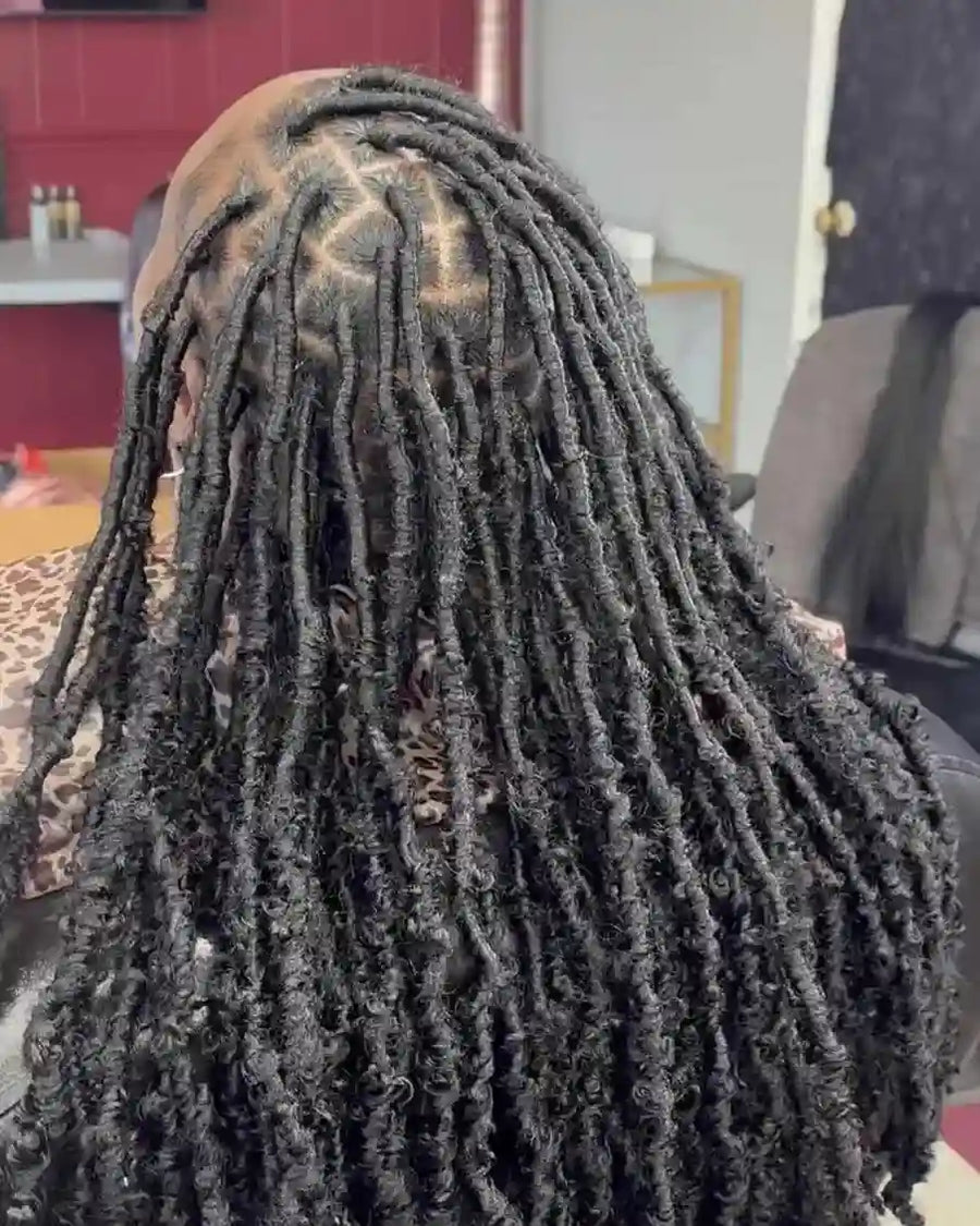 Person with long braided hair in an indoor setting