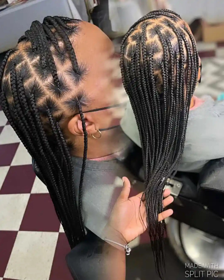 Person with braided hair styled in a leopard print pattern, sitting in a salon chair.