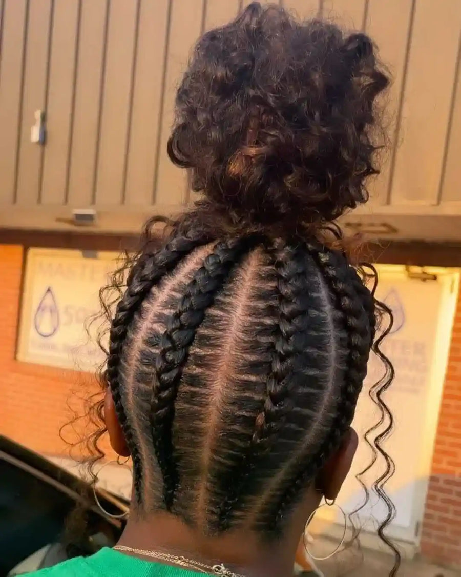 Person with braided hair in a salon setting