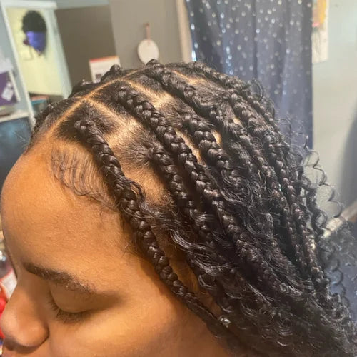 Close-up of braided hair with a blurred indoor background