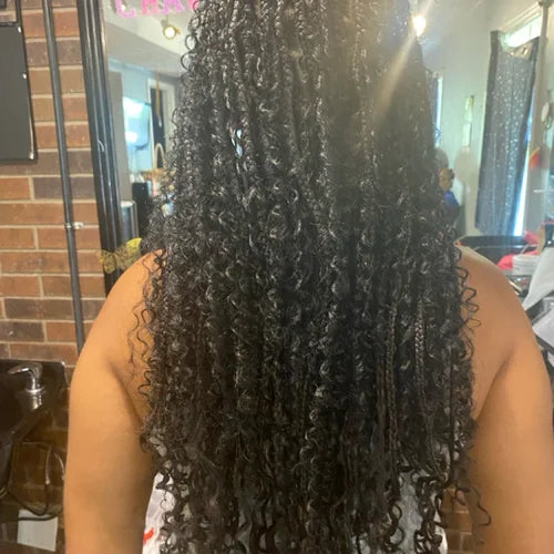 Person with long, curly hair in a salon setting