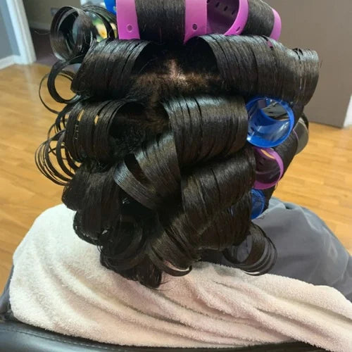 Hair in rollers on a towel with a neutral background