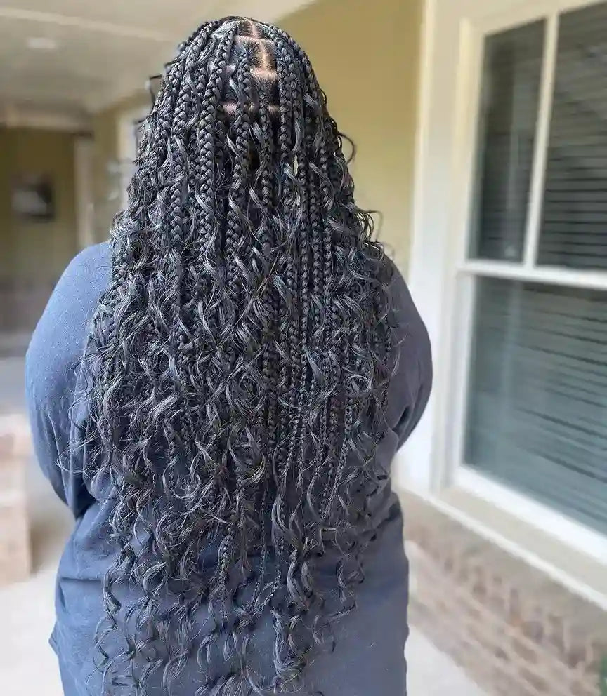 Person with long braided hair in a home setting