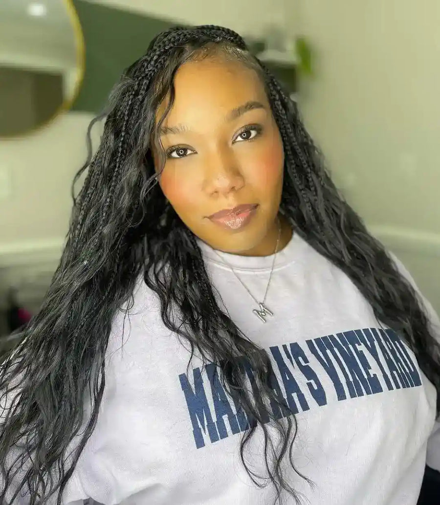 Person wearing a white sweatshirt with text in an indoor setting