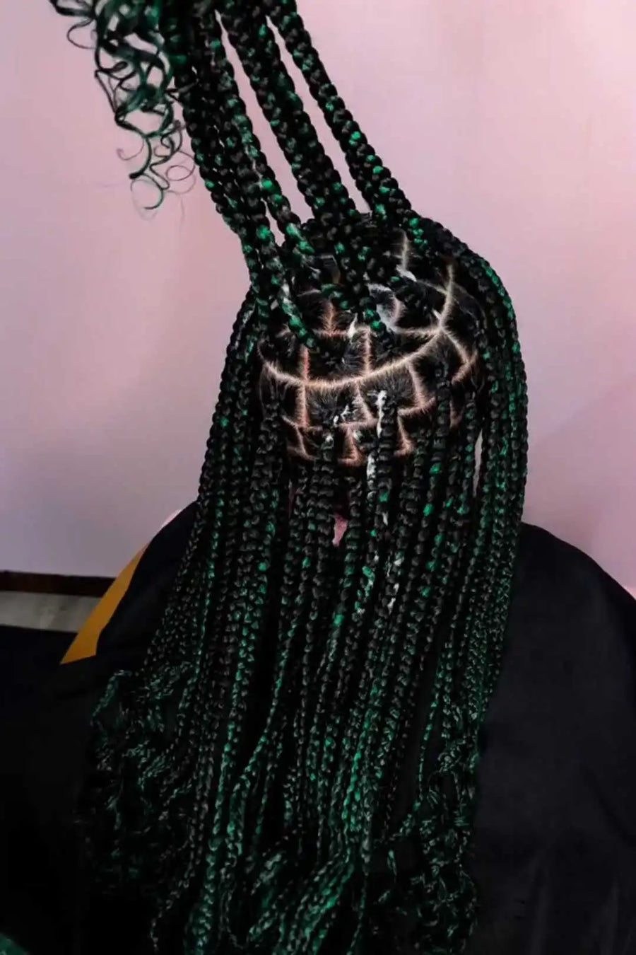 Green beaded bag with a decorative design on a plain background