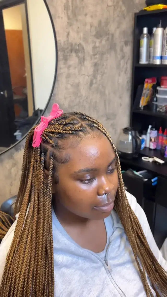 Woman with braided hair in a salon setting