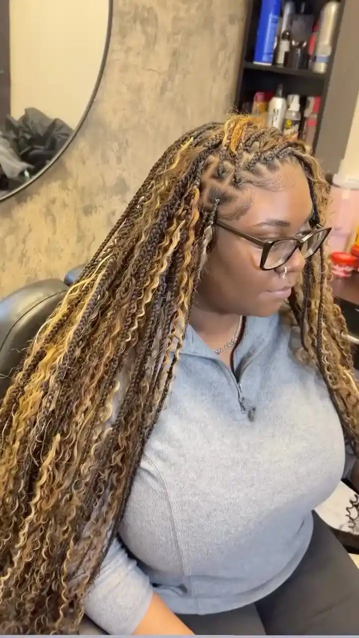 Woman with long braided hair in a salon setting