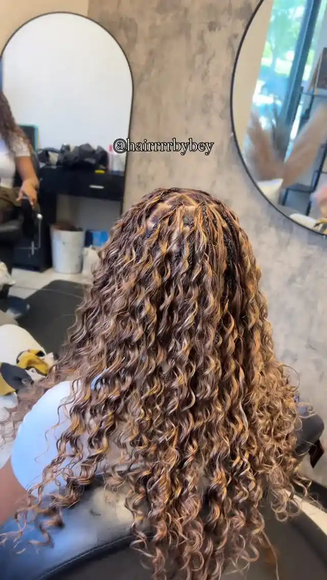 Person with curly hair in a salon setting