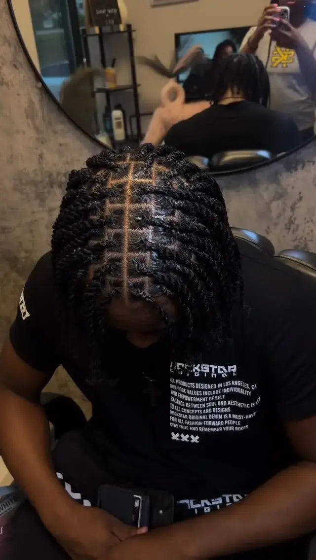 Person getting a haircut with a mirror reflecting the scene