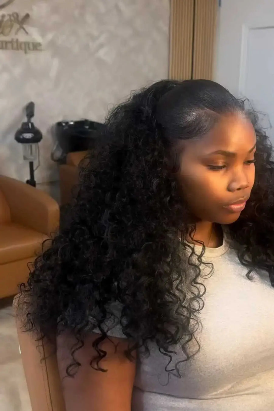 Woman with styled hair in a salon setting