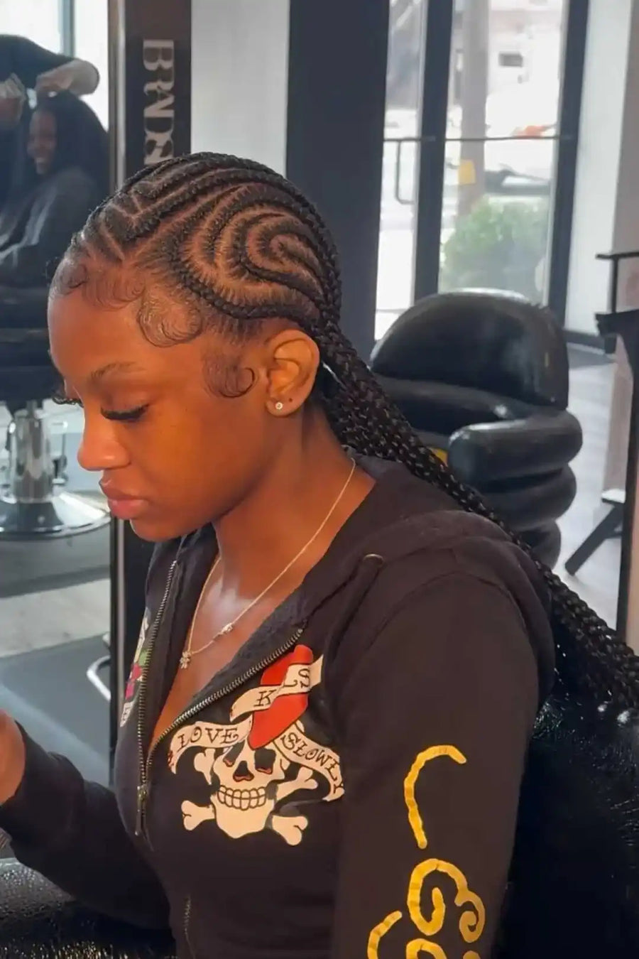 Woman with braided hair in a salon setting
