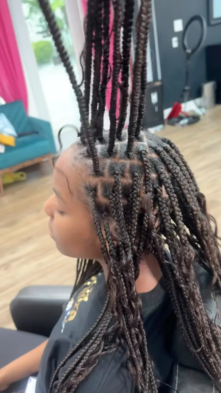 Knotless box braids with clean square parts and curly ends during installation, hairstylist located in Augusta, GA