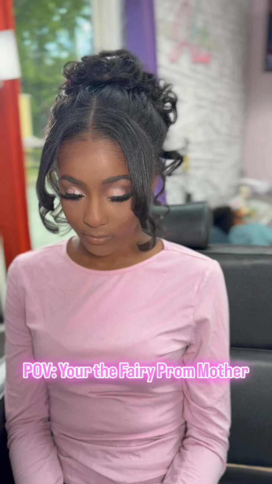Elegant high bun updo with side swoop and face-framing curls, hairstylist located in Augusta, GA