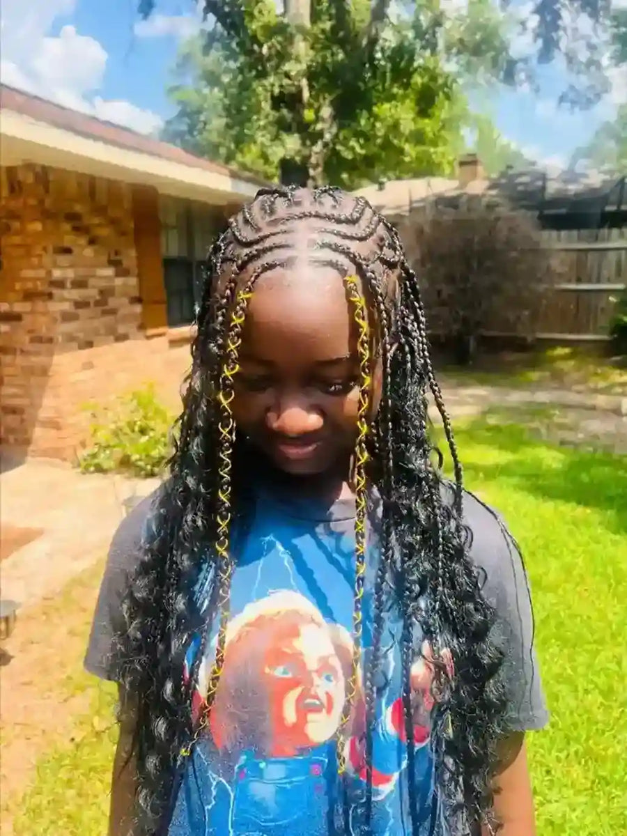 Child with braided hair wearing a graphic t-shirt outdoors