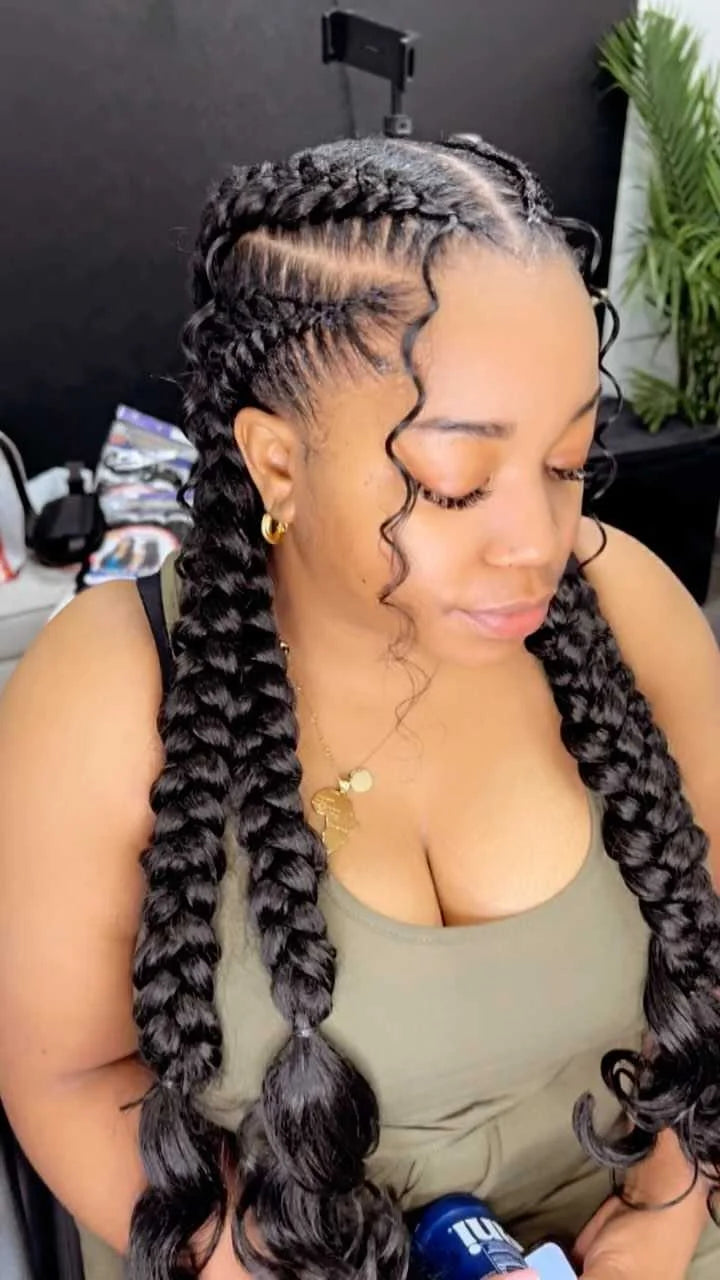 Woman with styled braids in a salon setting
