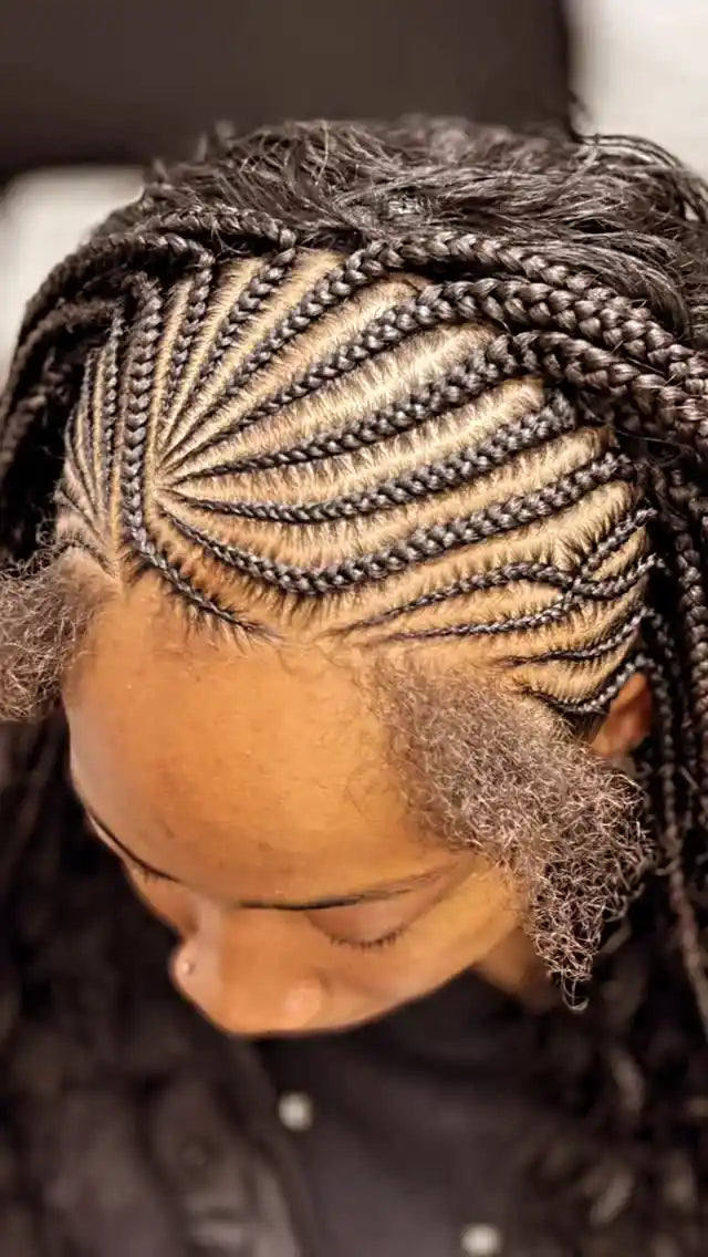 Close-up of a person with intricate braided hair style.