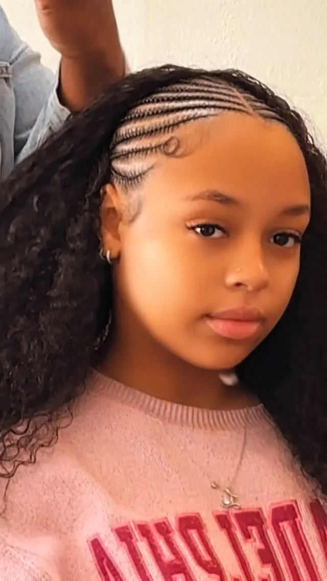 Young girl with braided hair wearing a pink sweater with text