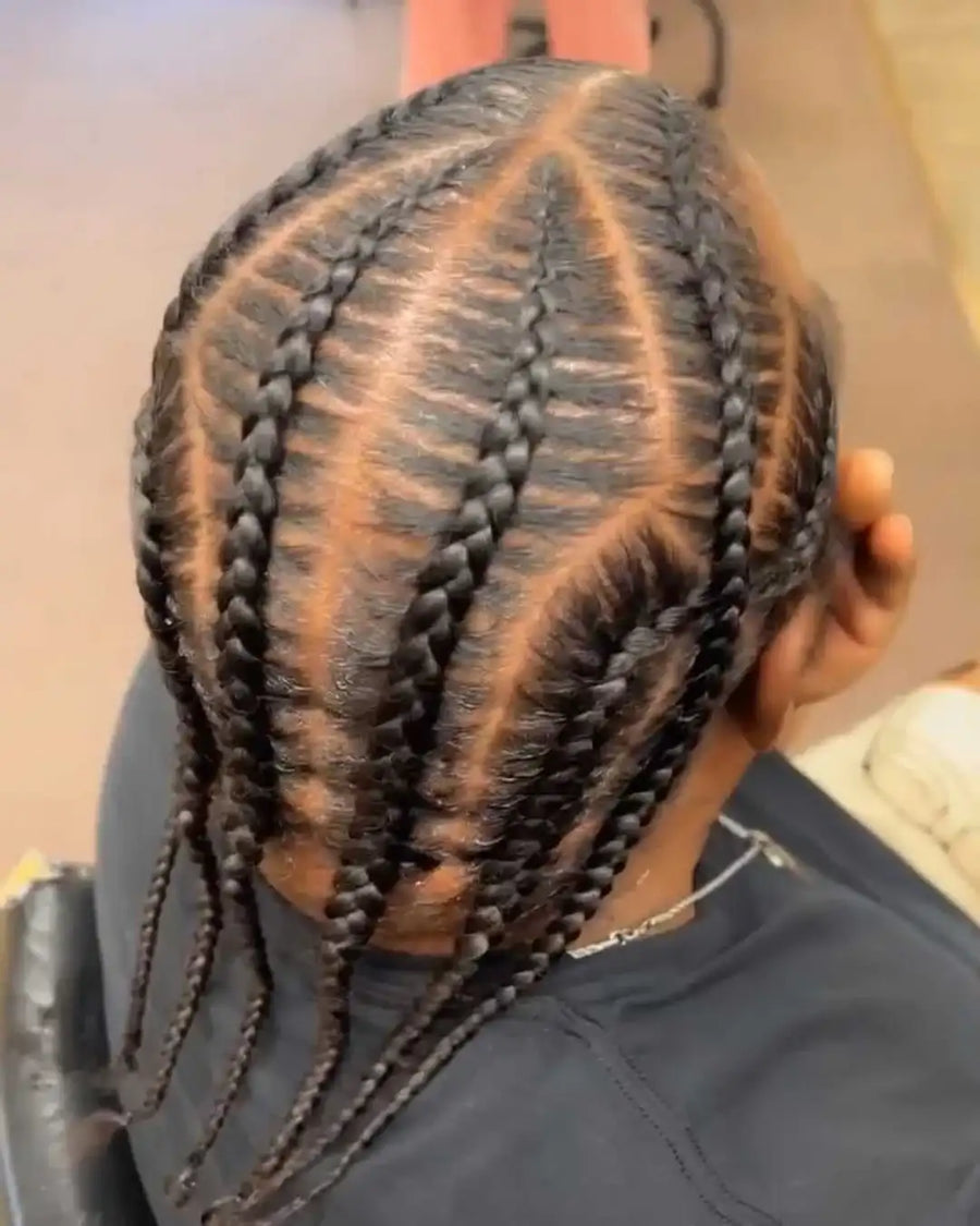 Person with braided hair in a salon setting