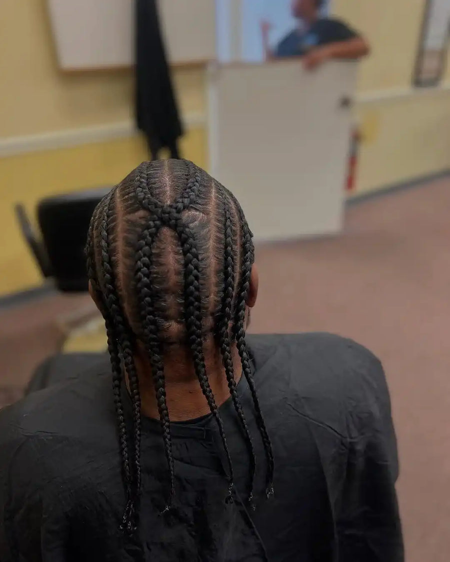 Person with braided hair in a classroom setting
